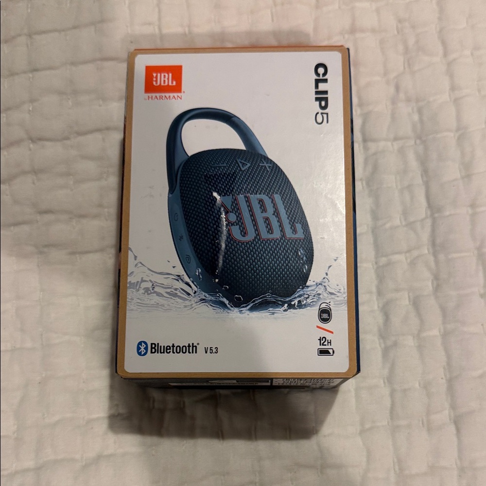 JBL Clip 5 Portable Speaker in Dark Blue with Orange Logo